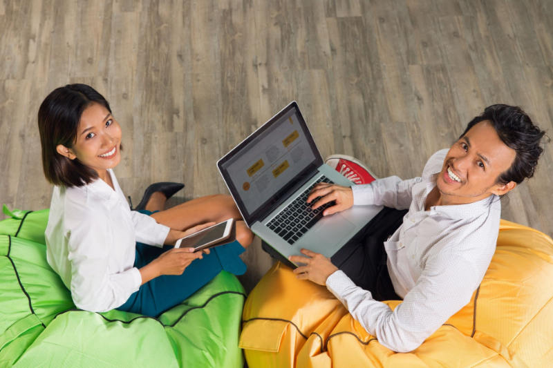 Photo of two web developers sitting on bean bags.
